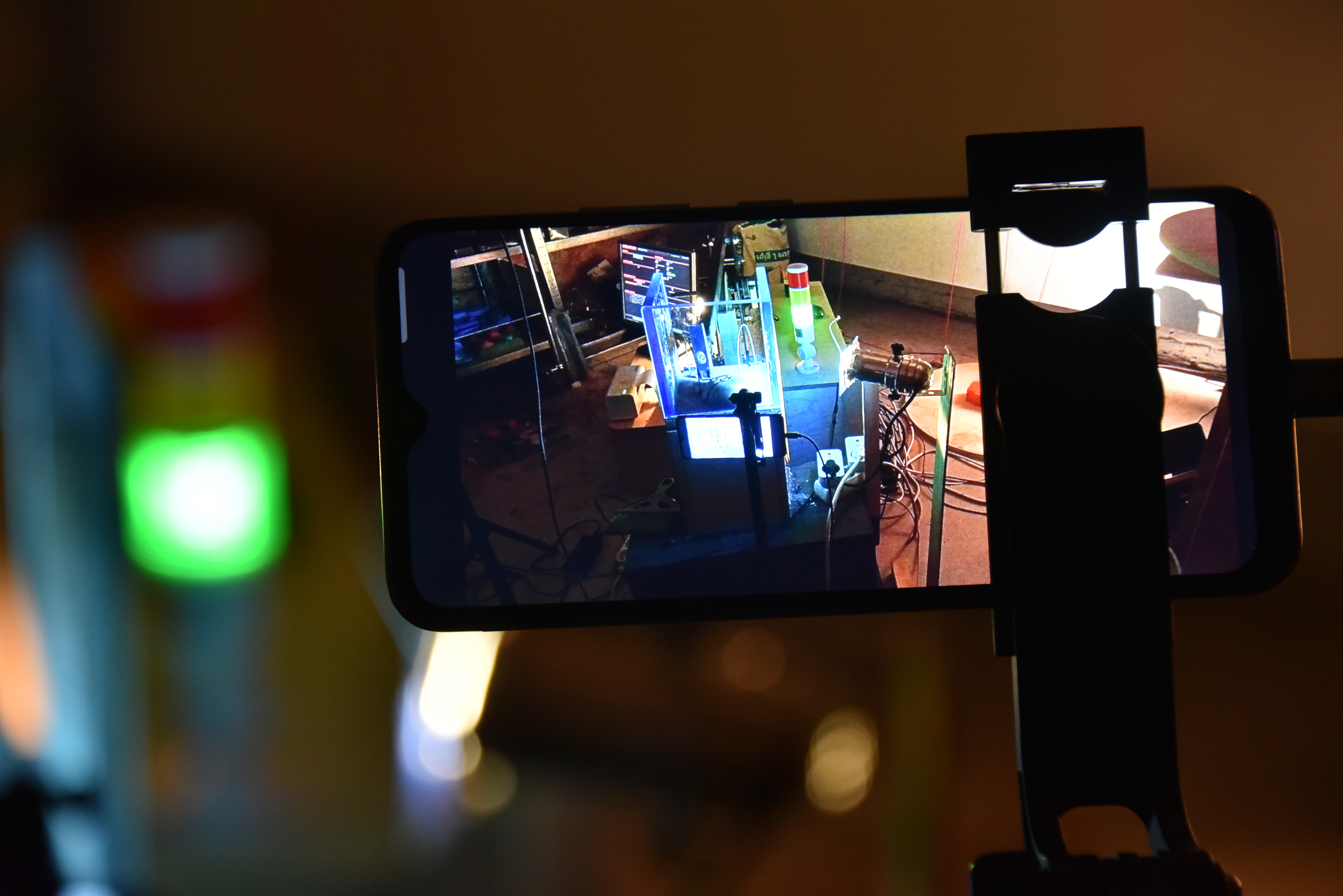A phone films the machine for the live broadcast